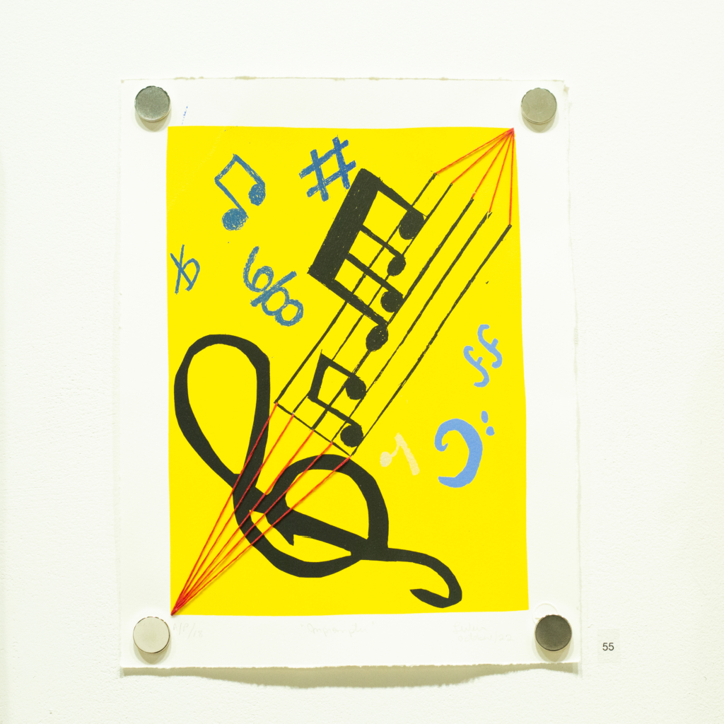 silkscreen print with music motes and embroidery