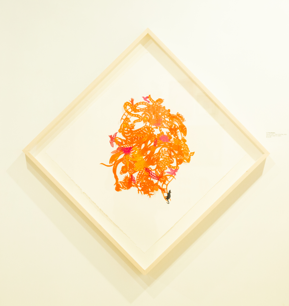 Paul Robles, cut origami picture in a frame, hung in a diamond fashion